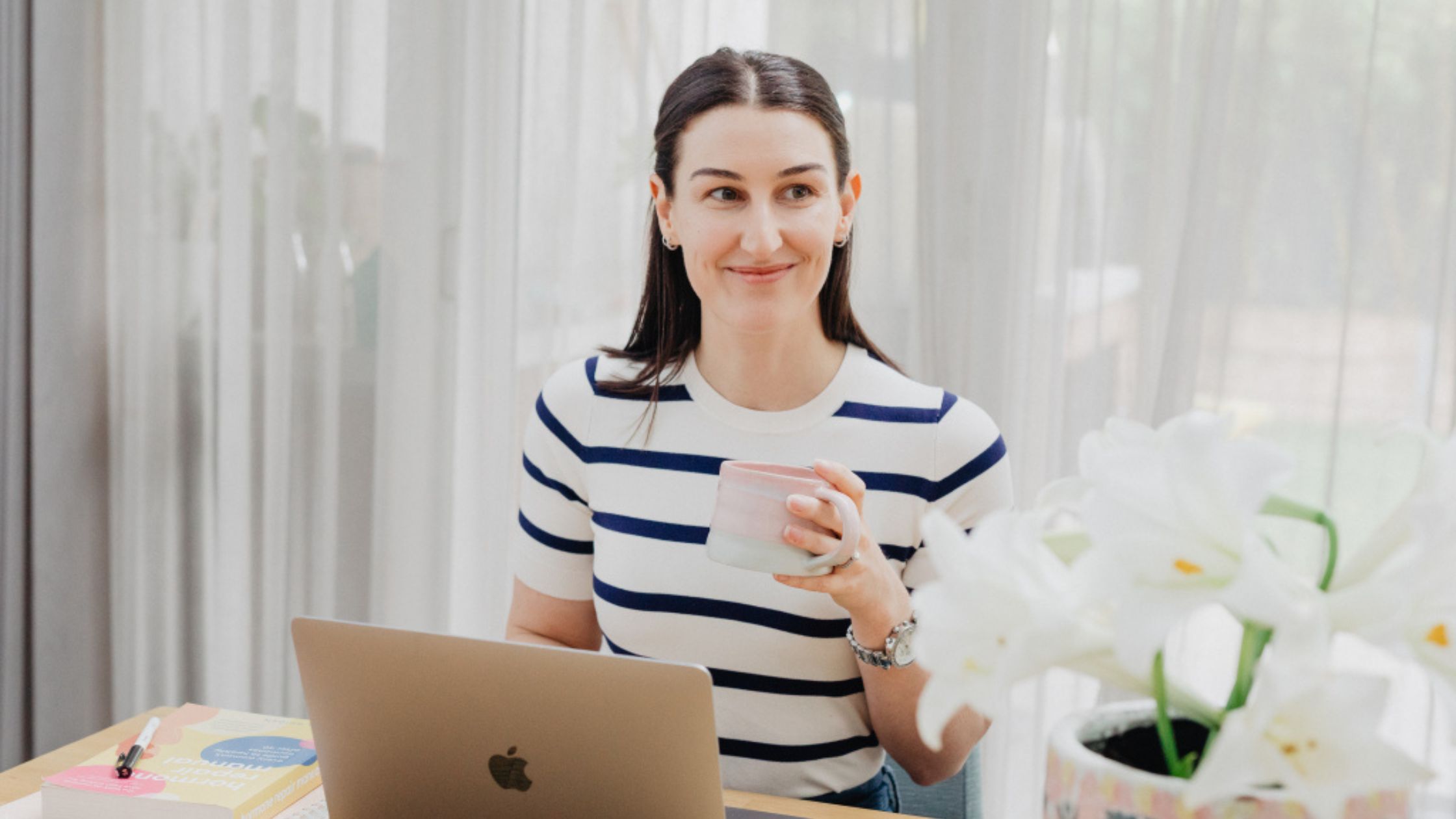 Clinical Nutritionist Jade Harman working at her desk, offering online nutrition consultations covered by private health insurance in Australia.